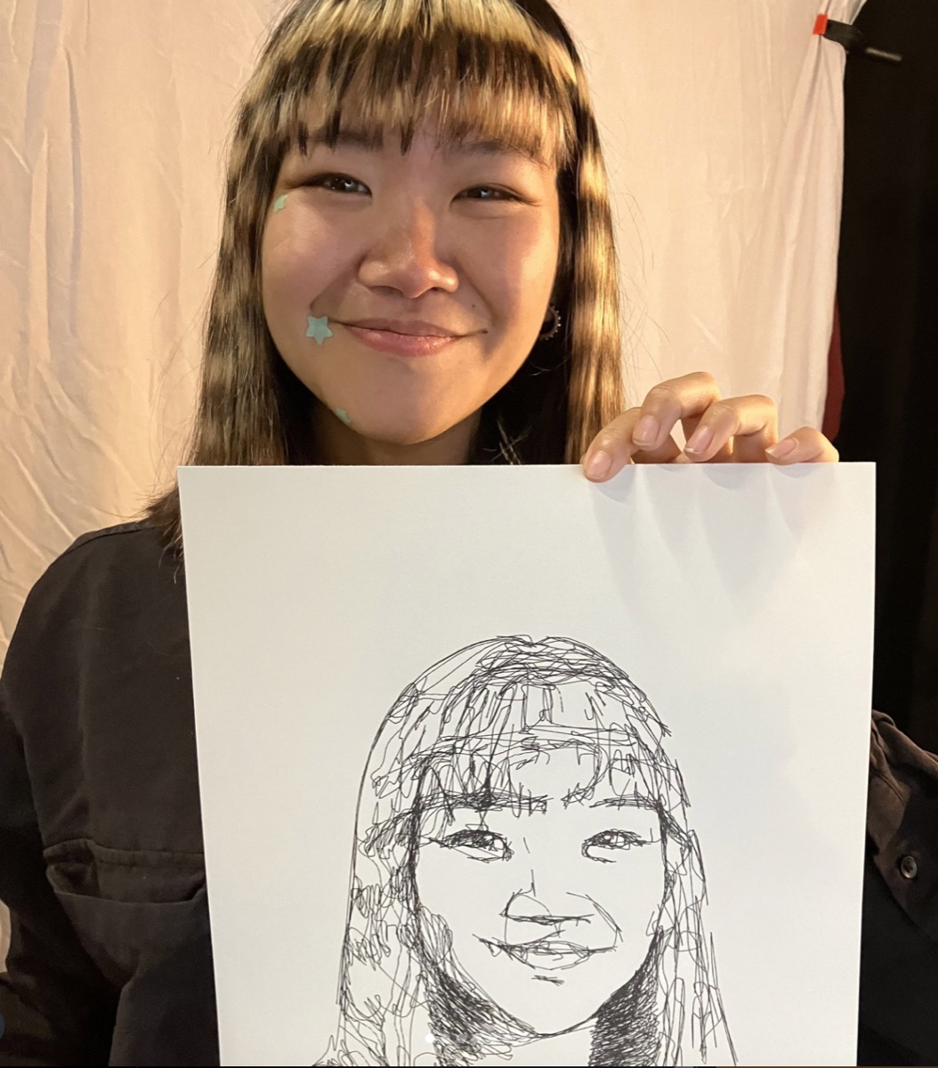 Live AI-powered portrait drawing machine sketching a visitor